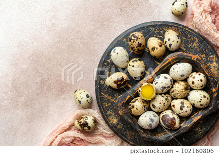 Fresh quail eggs in a wooden plate. Healthy food. View from above. 102160806