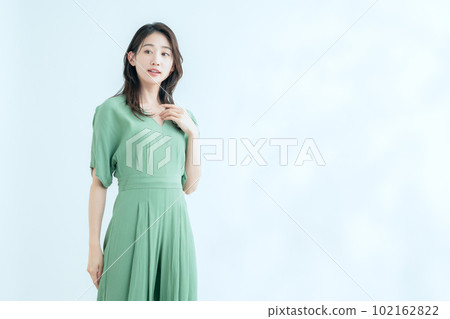 A young woman who does skin care in the white background of sunlight filtering through foliage A young woman who does skin care in the white background of sunlight filtering through foliage 102162822