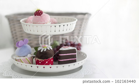 A vase with multi-colored pastries stands on a white background. There is a place to write 102163440