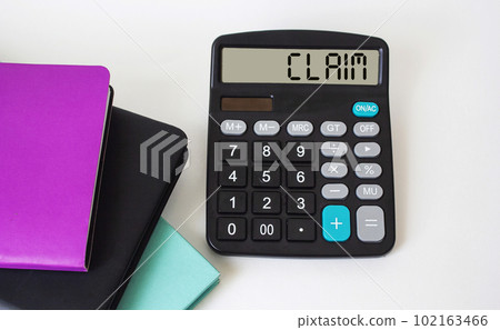 Claim text calculator and colored notepads on white background Claim text calculator and colored notepads on white background 102163466