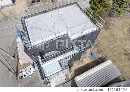 Aerial view of housing renovation Working on exterior wall painting Aerial view of housing renovation Working on exterior wall painting 102163494