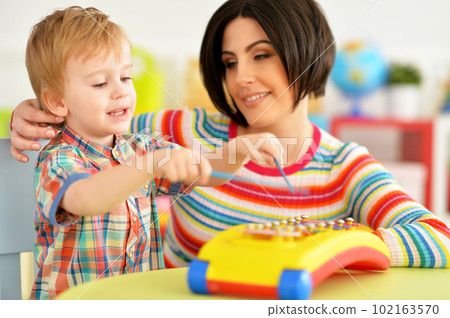 Young mother and cute little son playing Young mother and cute little son playing 102163570