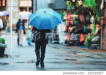 A businessman pointing an umbrella A businessman pointing an umbrella 102164957