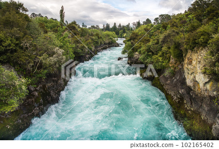 The upstream of Huka falls an iconic tourist most natural attraction place in Taupo, New Zealand. View from pedestrian bridge. 102165402