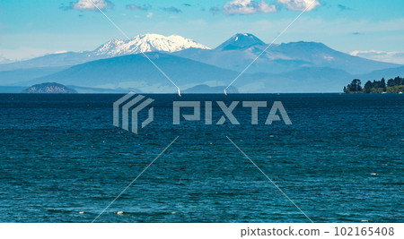 The landscape of great lake Taupo the largest freshwater lake in New Zealand with the volcanic landscape of Tongariro national park at the background. 102165408