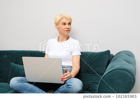 Senior woman was distracted during an online conversation 102165903
