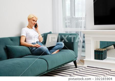 Middle-aged woman solves everyday problems remotely 102165904