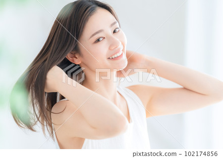 Young woman holding a bouquet in the living room Young woman holding a bouquet in the living room 102174856