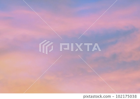 Sky with soft and fluffy pastel orange pink and blue colored clouds. Sunset background. Nature. sunrise. 102175038