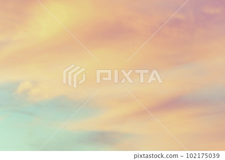Sky with soft and fluffy pastel orange pink and blue colored clouds. Sunset background. Nature. sunrise. 102175039