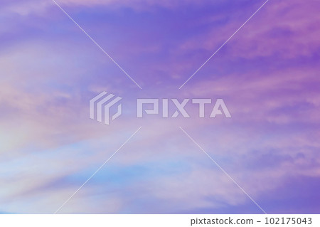 Sky with soft and fluffy pastel orange pink and blue colored clouds. Sunset background. Nature. sunrise. 102175043