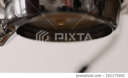 Closeup of pouring fresh espresso with bottomless portafilter Closeup of pouring fresh espresso with bottomless portafilter 102175092