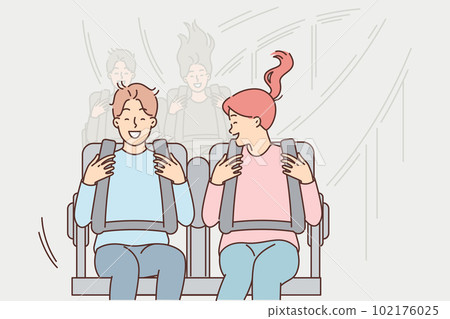 Young couple rides roller coaster enjoying extreme attractions in city park on weekends Young couple rides roller coaster enjoying extreme attractions in city park on weekends 102176025