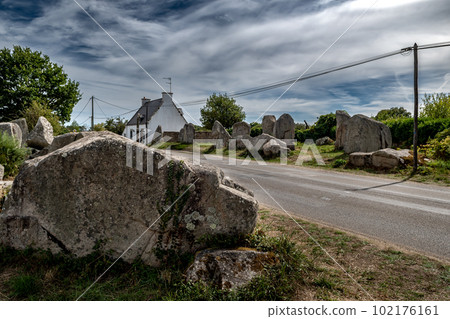 Ancient Stone Field Kerzerho Cruzuno With Neolithic Megaliths And Cottage Near Finistere Village Carnac In Brittany, France 102176161