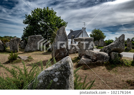 Ancient Stone Field Kerzerho Cruzuno With Neolithic Megaliths And Cottage Near Finistere Village Carnac In Brittany, France 102176164