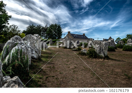 Ancient Stone Field Kerzerho Cruzuno With Neolithic Megaliths And Cottage Near Finistere Village Carnac In Brittany, France Ancient Stone Field Kerzerho Cruzuno With Neolithic Megaliths And Cottage Near Finistere Village Carnac In Brittany, France 102176179