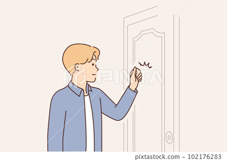 Young man knocks on door when comes to visit friend or company office to get job 102176283