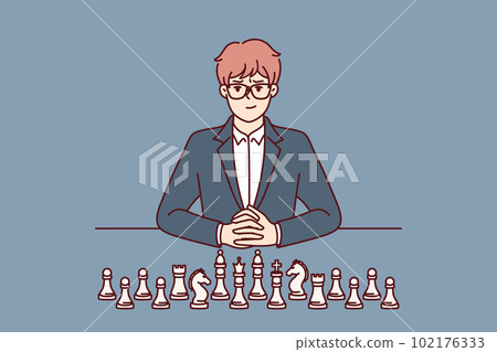 Business man with chess pieces sits at table and looks at screen for concept of strategic planning 102176333