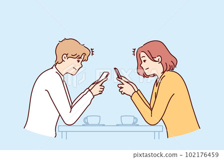 Couple with phones sits in cafe, addiction to social networks, not paying attention to interlocutor Couple with phones sits in cafe, addiction to social networks, not paying attention to interlocutor 102176459