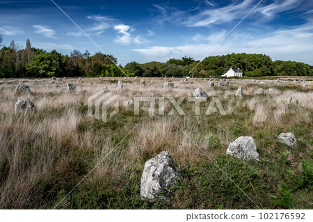 Ancient Stone Field Alignements De Menhir Carnac With Neolithic Megaliths And Old Cottage In Brittany, France Ancient Stone Field Alignements De Menhir Carnac With Neolithic Megaliths And Old Cottage In Brittany, France 102176592