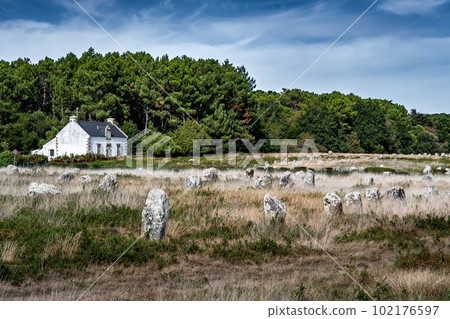 Ancient Stone Field Alignements De Menhir Carnac With Neolithic Megaliths And Old Cottage In Brittany, France Ancient Stone Field Alignements De Menhir Carnac With Neolithic Megaliths And Old Cottage In Brittany, France 102176597