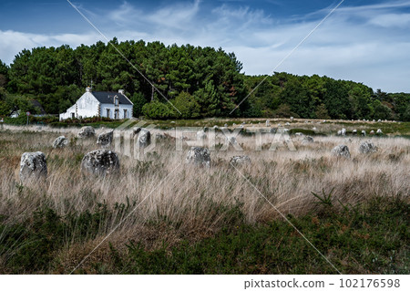 Ancient Stone Field Alignements De Menhir Carnac With Neolithic Megaliths And Old Cottage In Brittany, France 102176598