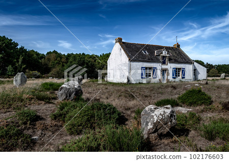 Ancient Stone Field Alignements De Menhir Carnac With Neolithic Megaliths And Old Cottage In Brittany, France Ancient Stone Field Alignements De Menhir Carnac With Neolithic Megaliths And Old Cottage In Brittany, France 102176603