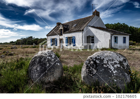 Ancient Stone Field Alignements De Menhir Carnac With Neolithic Megaliths And Old Cottage In Brittany, France Ancient Stone Field Alignements De Menhir Carnac With Neolithic Megaliths And Old Cottage In Brittany, France 102176605