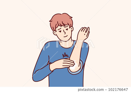 Man smears elbow with healing dermatological ointment after bruise or skin problems and acne 102176647