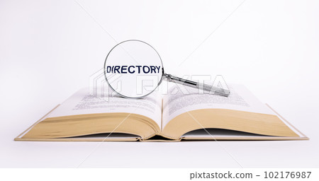 Directory word on book through magnifier Directory word on book through magnifier 102176987