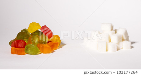 Gummy jelly bears, chewing fruit candies and refined sweet sugar piles. Consumprion and addiction 102177264