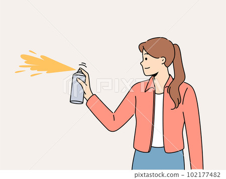 Smiling girl spray with paint on wall  102177482