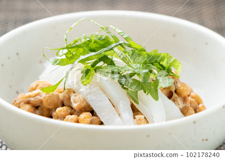 Natto arrangement. Kensaki squid sashimi topped with tiny grains of natto. Natto arrangement. Kensaki squid sashimi topped with tiny grains of natto. 102178240