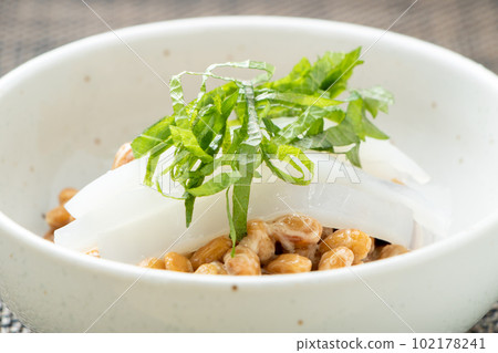 Natto arrangement. Kensaki squid sashimi topped with tiny grains of natto. 102178241