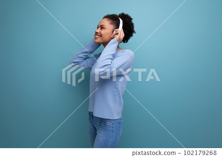 stylish photo portrait of energetic 20s young afro brunette woman listening to music using white stylish photo portrait of energetic 20s young afro brunette woman listening to music using white 102179268