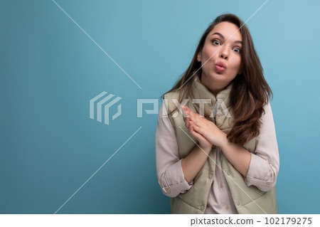 coquettish young brunette female adult in casual outfit flirting on studio background coquettish young brunette female adult in casual outfit flirting on studio background 102179275