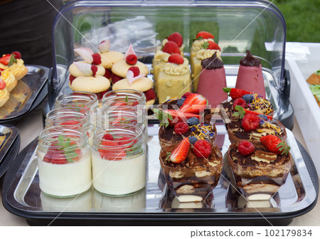 Stand of a local confectioner offering cakes and other desserts. Stand of a local confectioner offering cakes and other desserts. 102179834