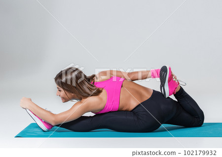 Sporty flexible girl doing stretching exercise Sporty flexible girl doing stretching exercise 102179932