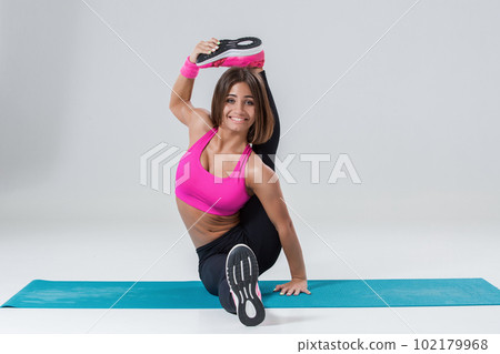 Sporty flexible girl doing stretching exercise Sporty flexible girl doing stretching exercise 102179968