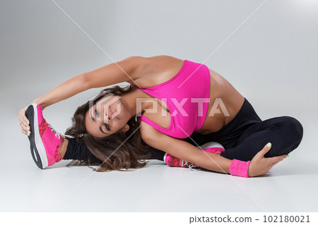 Sporty flexible girl doing stretching exercise Sporty flexible girl doing stretching exercise 102180021