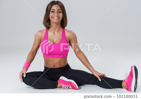 Sporty flexible girl doing stretching exercise Sporty flexible girl doing stretching exercise 102180031