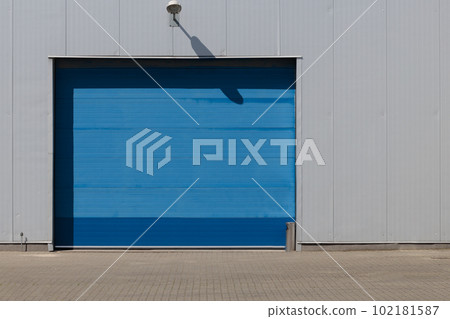 Industrial blue roller shutter door for loading dock in factory building. Industrial blue roller shutter door for loading dock in factory building. 102181587