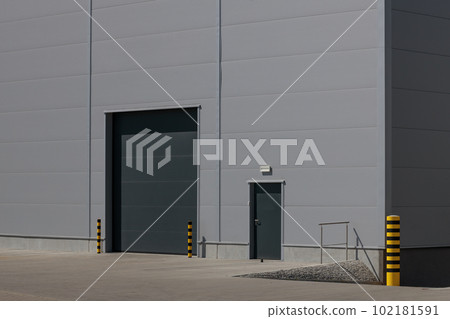 Grey roller shutter entrance for industrial building's loading area. 102181591