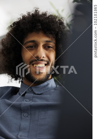 Arab start up company employee talking in remote conference while working in business office. Young smiling businessman discussing project plan in videocall using digital tablet Arab start up company employee talking in remote conference while working in business office. Young smiling businessman discussing project plan in videocall using digital tablet 102181865