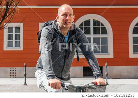 Portrait of a handsome hipster man. A man in a big city cycling down the street on a bicycle, a life style concept 102182255