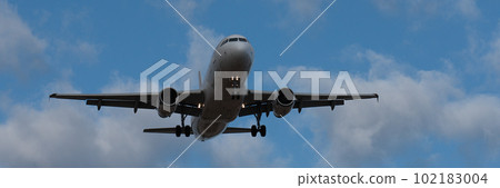 Landscape with white passenger airplane is flying in the blue sky with clouds at overcast day. Landing airplane. Travel background. Passenger airliner. Business trip. Commercial aircraft Landscape with white passenger airplane is flying in the blue sky with clouds at overcast day. Landing airplane. Travel background. Passenger airliner. Business trip. Commercial aircraft 102183004