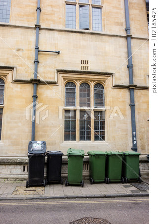 A light brown stone building and a large garbage bin placed in front of it The streets of Oxford A light brown stone building and a large garbage bin placed in front of it The streets of Oxford 102185425