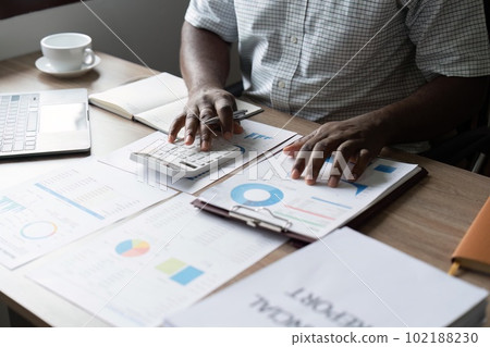 Accountant or bookkeeper working on desk using calculator for calculate finance report in office Accountant or bookkeeper working on desk using calculator for calculate finance report in office 102188230