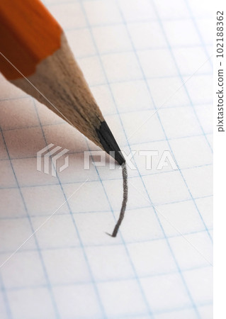 Writing with pencil on white paper closeup Writing with pencil on white paper closeup 102188362