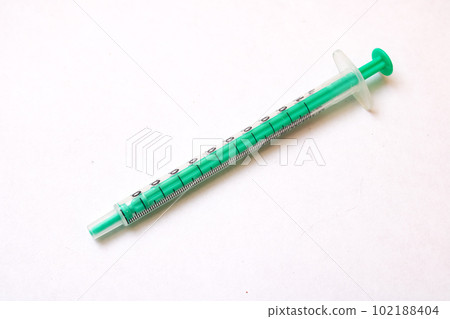 Large medical syringe on a gray background Large medical syringe on a gray background 102188404